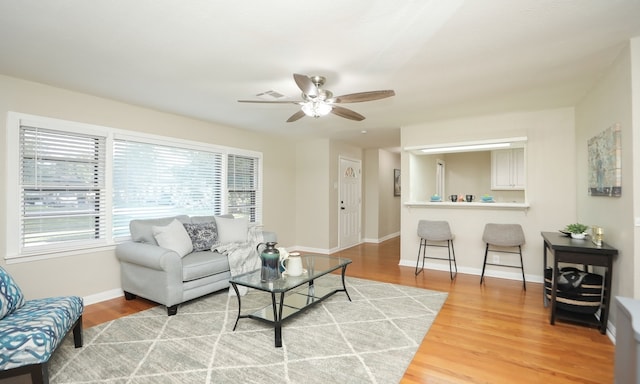 living room featuring ceiling fan and hardwood / wood-style floors