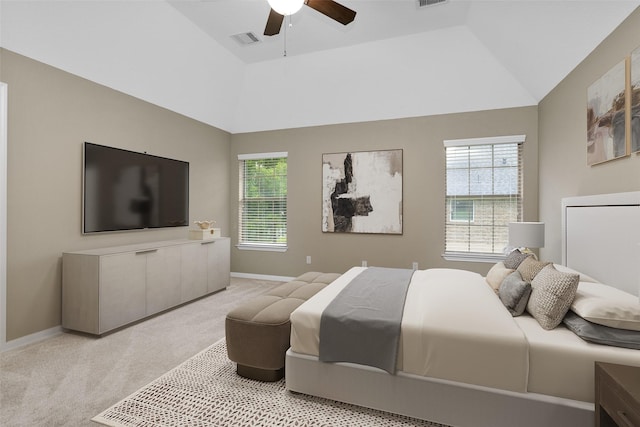 bedroom featuring multiple windows, ceiling fan, light carpet, and vaulted ceiling