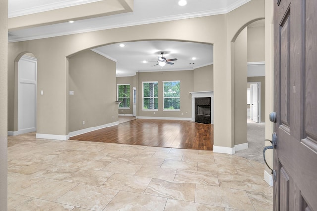 interior space with light hardwood / wood-style flooring, ceiling fan, and crown molding