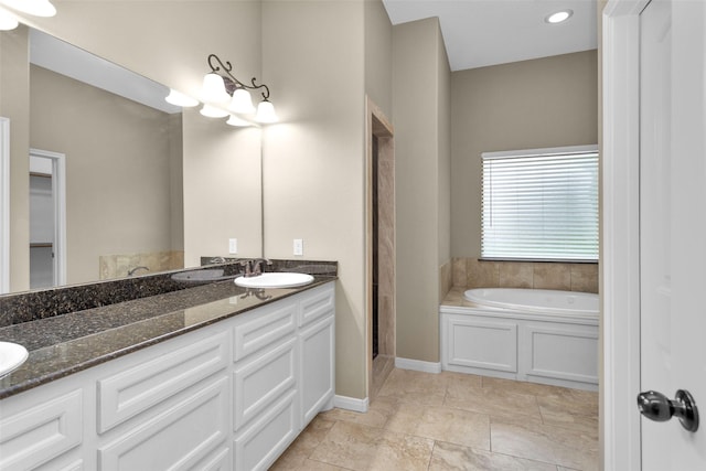 bathroom with a washtub and vanity