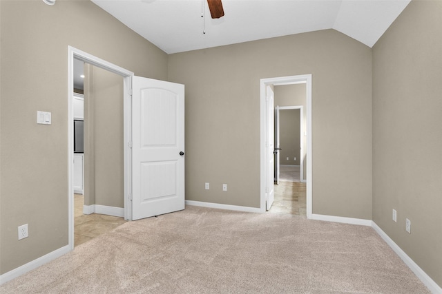 unfurnished bedroom with light carpet, ceiling fan, and lofted ceiling