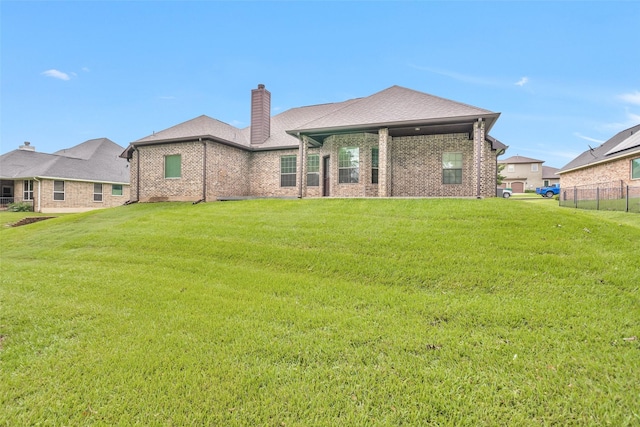 back of house featuring a lawn