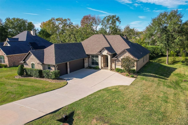 view of front of property featuring a front yard and a garage