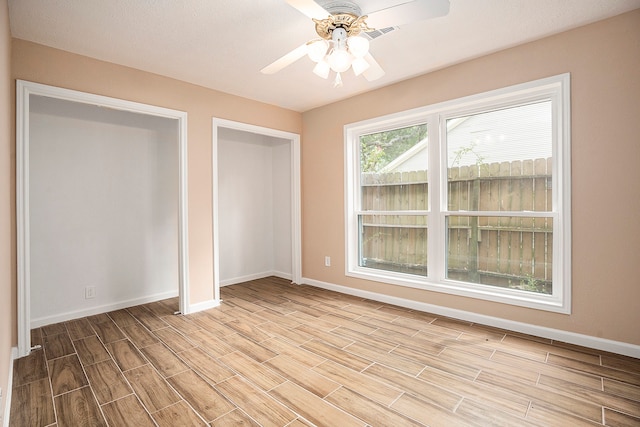 unfurnished bedroom with ceiling fan and light hardwood / wood-style flooring