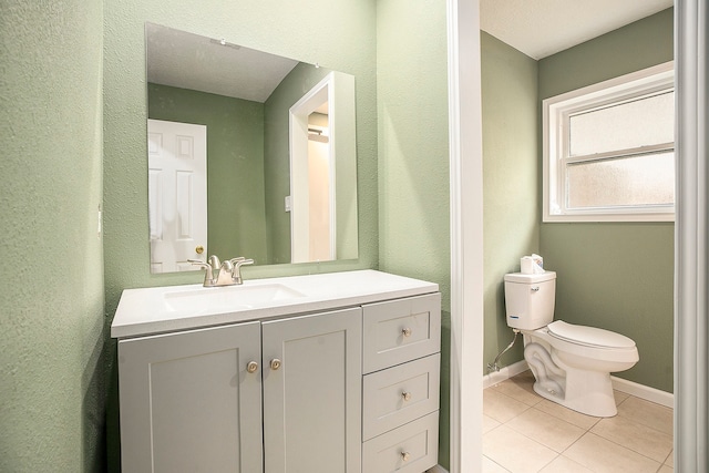 bathroom with vanity, toilet, and tile patterned floors