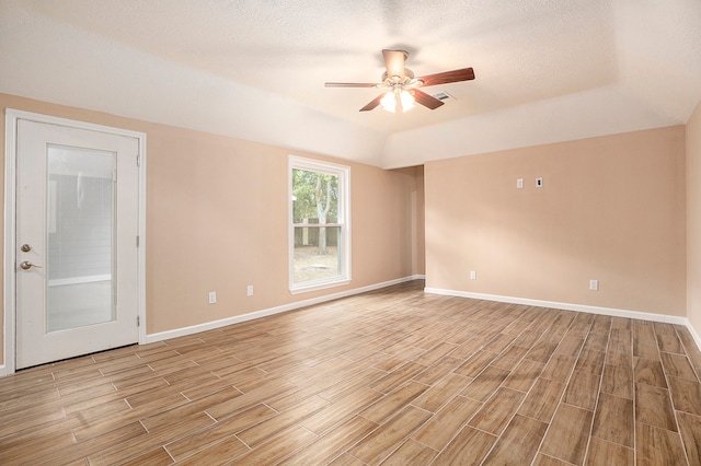 unfurnished room with light hardwood / wood-style floors, a textured ceiling, and ceiling fan