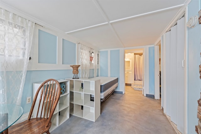 bedroom featuring concrete flooring