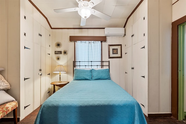 bedroom featuring ornamental molding, ceiling fan, an AC wall unit, and dark hardwood / wood-style flooring