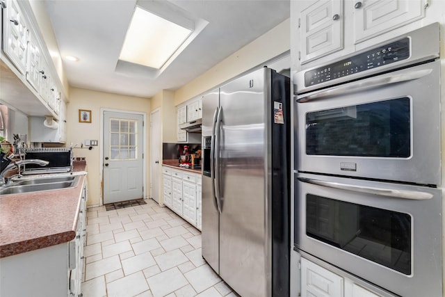 kitchen with white cabinets, sink, and appliances with stainless steel finishes