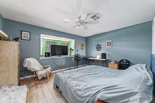 bedroom with light hardwood / wood-style floors and ceiling fan