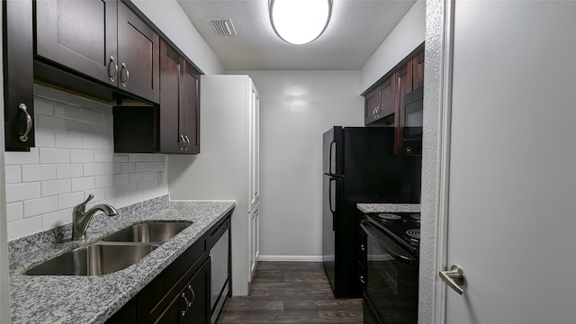 kitchen featuring sink, black appliances, light stone countertops, and dark wood-type flooring