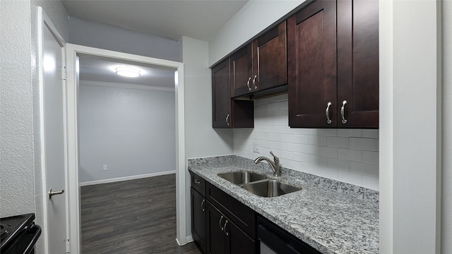 kitchen with tasteful backsplash, electric range, light stone countertops, dark wood-type flooring, and sink