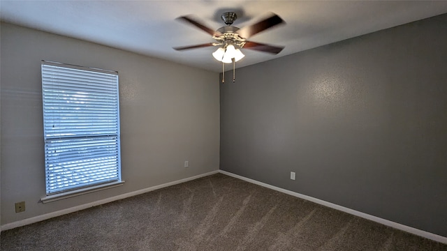 carpeted spare room with ceiling fan