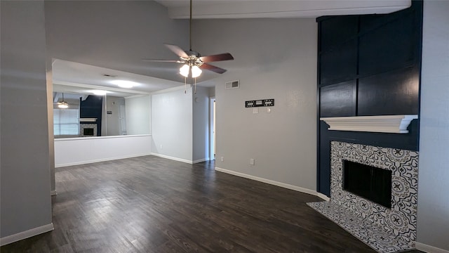 unfurnished living room featuring a tiled fireplace, vaulted ceiling with beams, dark hardwood / wood-style floors, and ceiling fan