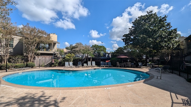 view of swimming pool with a patio