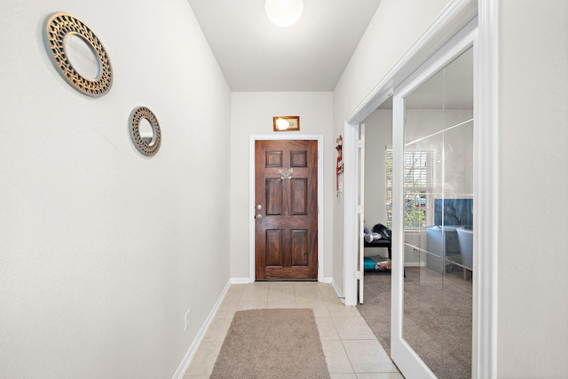 doorway with light tile patterned floors