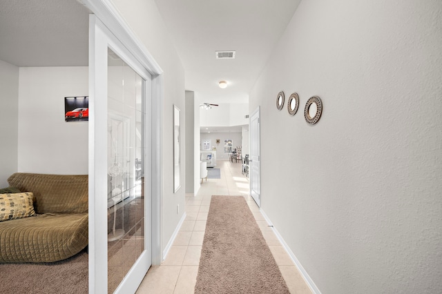 hallway featuring light tile patterned flooring