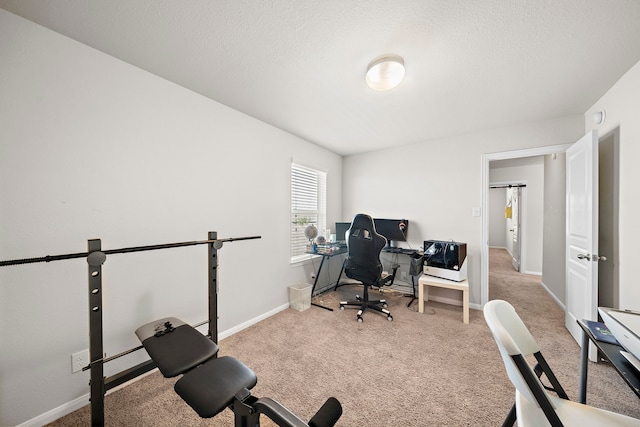 carpeted office space featuring a textured ceiling