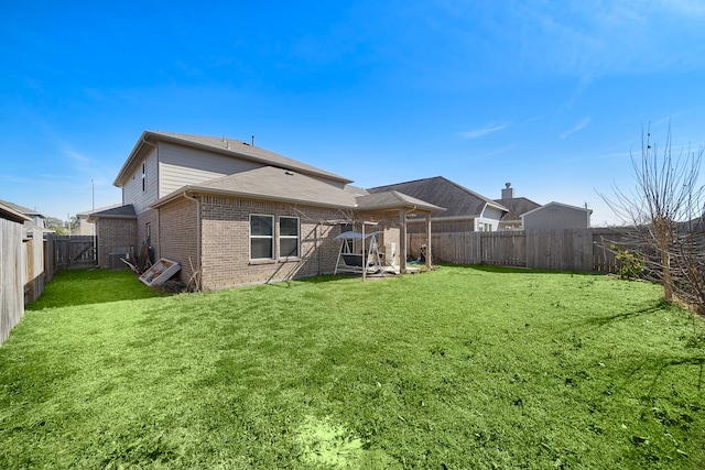 rear view of house with a yard