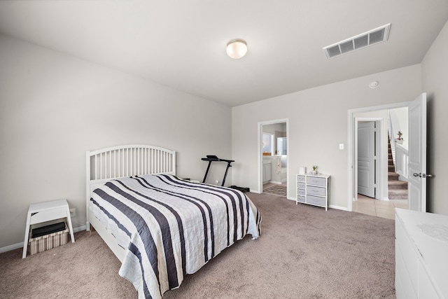 carpeted bedroom with ensuite bath