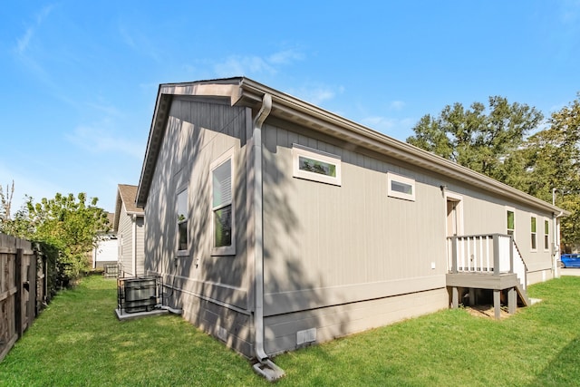 back of house featuring a yard and central air condition unit