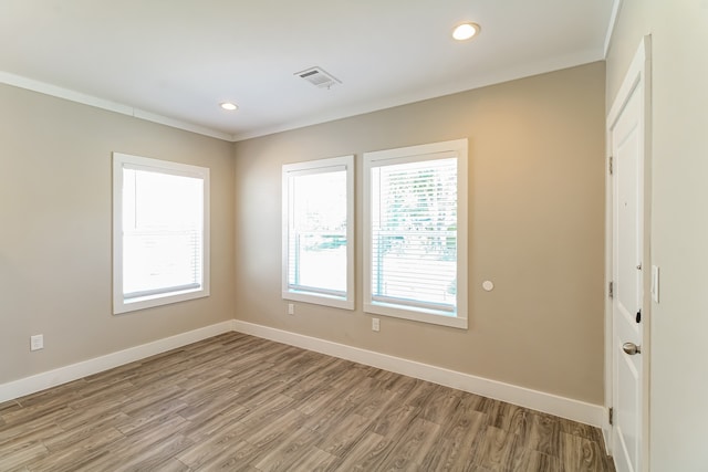 unfurnished room featuring ornamental molding and hardwood / wood-style floors