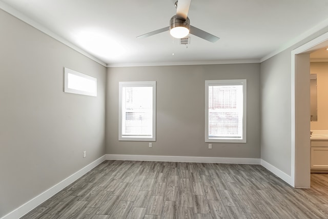 unfurnished room featuring ornamental molding, light wood-type flooring, and ceiling fan