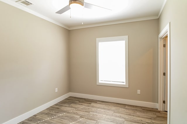 unfurnished room with crown molding, light hardwood / wood-style flooring, and ceiling fan