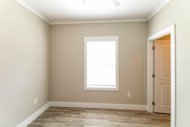 empty room featuring light hardwood / wood-style flooring and crown molding