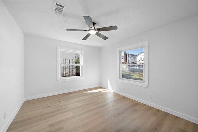 empty room with light hardwood / wood-style floors and ceiling fan