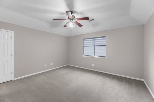 empty room featuring ceiling fan, carpet floors, and a textured ceiling