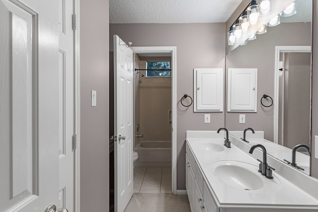 full bathroom featuring vanity, a textured ceiling,  shower combination, tile patterned flooring, and toilet