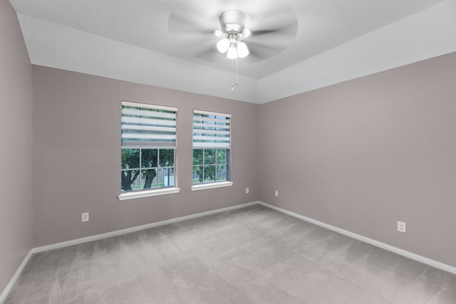 carpeted empty room featuring a textured ceiling and ceiling fan