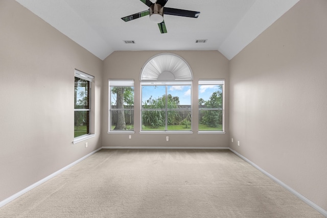 unfurnished room with ceiling fan, light colored carpet, and lofted ceiling