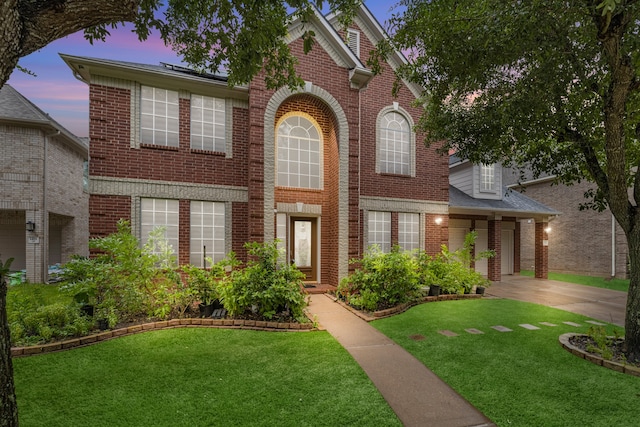 view of front of property with a lawn and a garage