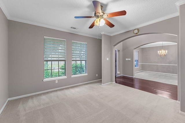 spare room with ceiling fan with notable chandelier, a textured ceiling, light colored carpet, and crown molding