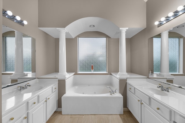 bathroom with vanity and a tub