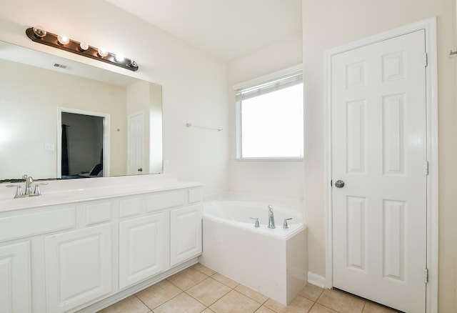 bathroom with vanity, a tub to relax in, and tile patterned flooring