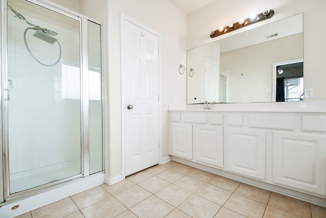 bathroom with vanity, an enclosed shower, and tile patterned flooring