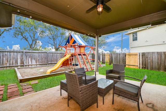 view of patio with a playground and ceiling fan