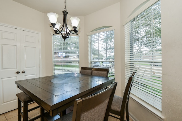 dining room featuring a notable chandelier and light tile patterned flooring