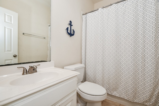 bathroom with vanity, toilet, curtained shower, and tile patterned flooring