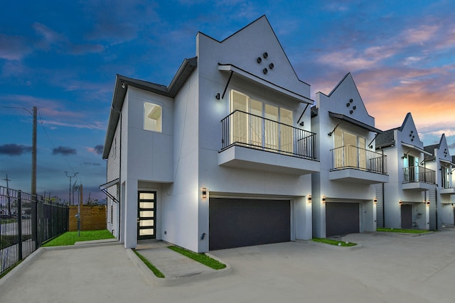 contemporary home featuring a garage and a balcony