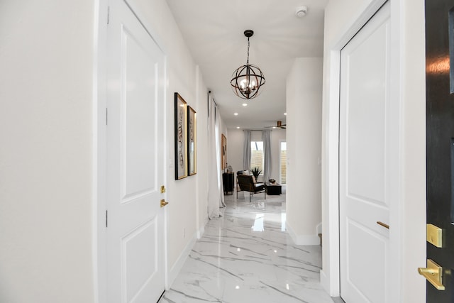 corridor with an inviting chandelier