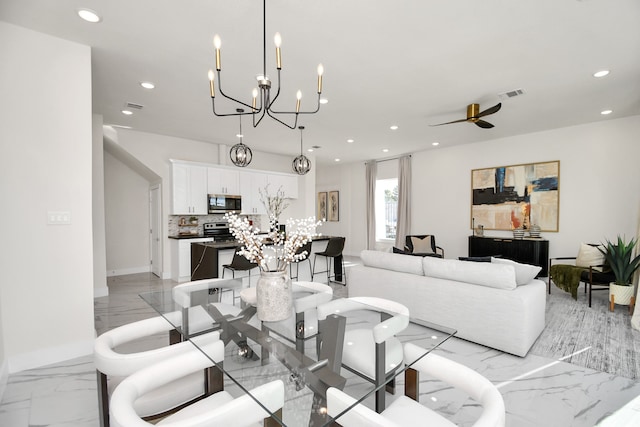 living room with ceiling fan with notable chandelier