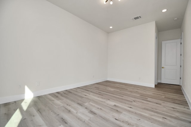 spare room with light hardwood / wood-style flooring