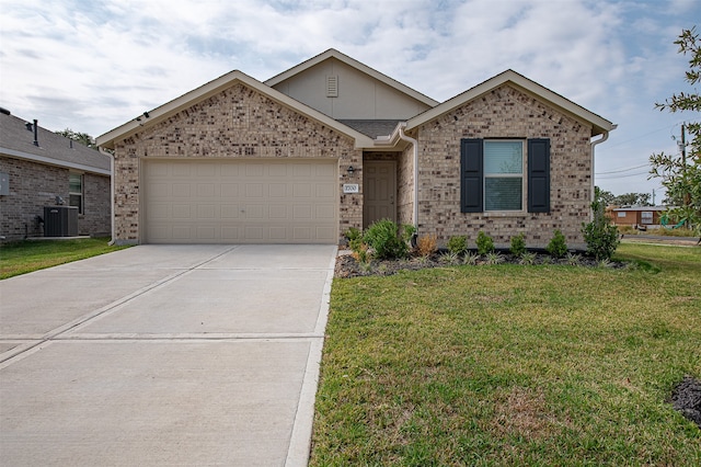 view of front facade featuring a front yard, a garage, and central AC unit