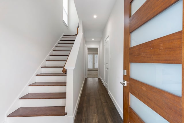 stairs featuring wood-type flooring