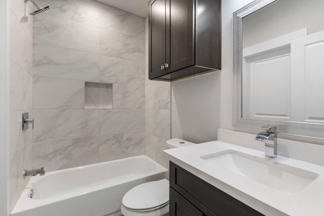 full bathroom with vanity, toilet, and tiled shower / bath