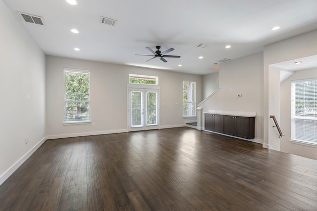 unfurnished living room with ceiling fan and dark hardwood / wood-style flooring